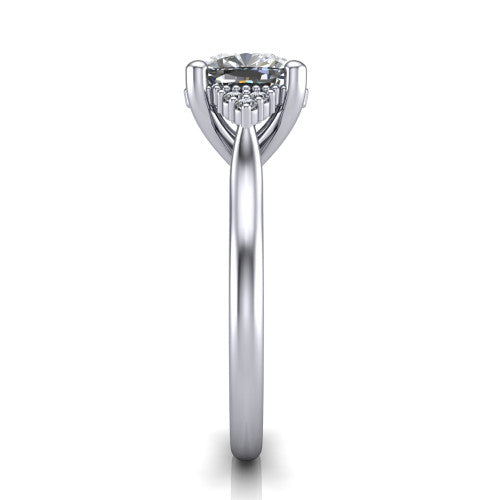 Brianna cushion three stone engagement ring in 18K White Gold with milgrain-framed center and round side clusters, side profile showing the plain band and side accent clusters