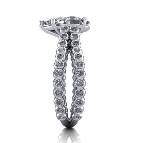 Magnolia pear classic engagement ring in Platinum, side profile showing the split bezel-set diamond band in side view