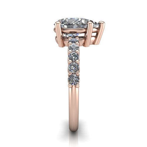 Fernanda pear solitaire engagement ring in 18K Rose Gold, side profile showing the 4-prong head and shared-prong pave band