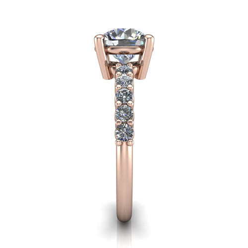 Fernanda round solitaire engagement ring in 18K Rose Gold, side profile showing the 4-prong head and shared-prong pave band