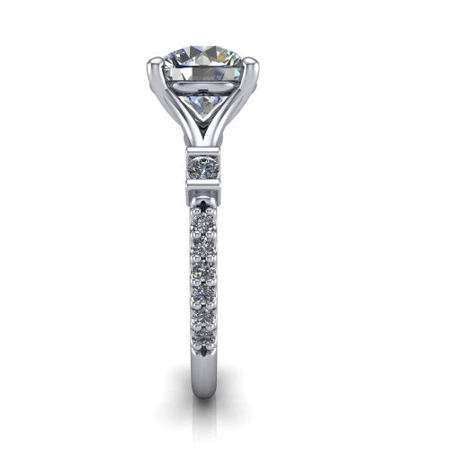 Arabella round solitaire engagement ring in Platinum, side profile showing the bezel-set square accents and pave band