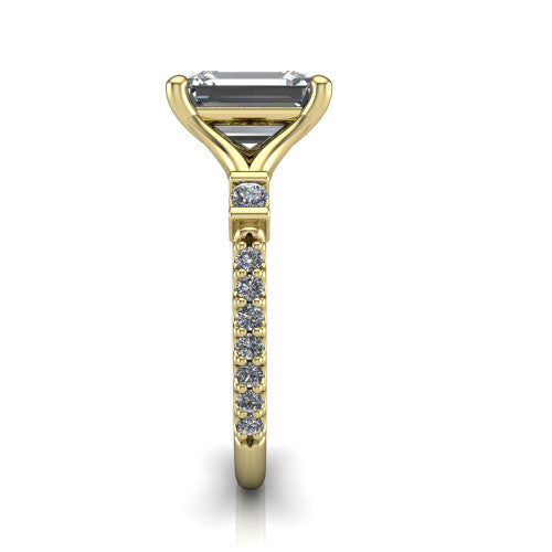 Arabella emerald solitaire engagement ring in 18K Yellow Gold, side profile showing the bezel-set square accents and pave band