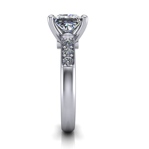 Nena princess solitaire engagement ring in Platinum, side profile showing the channel-set shoulder diamonds