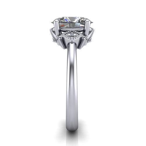 Harmony oval three stone engagement ring in Platinum, side profile showing the diamond side clusters and polished band