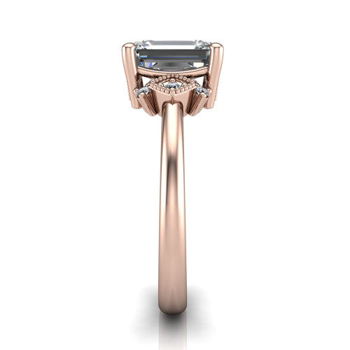 Harmony emerald-cut three stone engagement ring in 14K Rose Gold, side profile showing the diamond side clusters and polished band