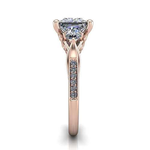 Celine princess three stone engagement ring in 18K Rose Gold, side profile showing the filigree gallery and pave diamond band along the shoulders
