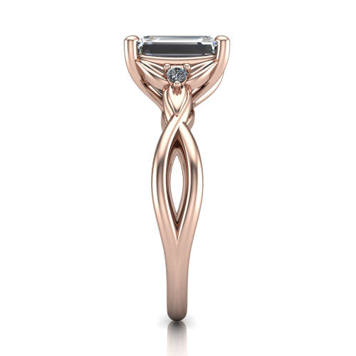 Catalina emerald three stone engagement ring in 18K Rose Gold, side profile showing the twisted infinity shank braiding beneath the head into a polished band