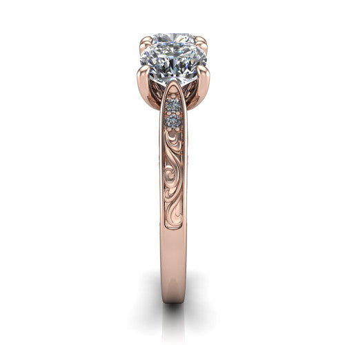 Navy cushion three stone engagement ring in 14K Rose Gold, side profile showing the vintage engraved filigree band and the raised three-stone setting