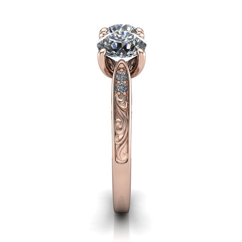 Navy round three stone engagement ring in 18K Rose Gold, side profile showing the vintage engraved filigree band and the raised three-stone setting