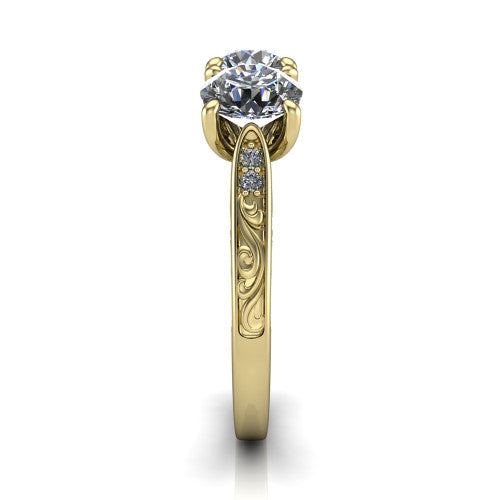 Navy round three stone engagement ring in 14K Yellow Gold, side profile showing the vintage engraved filigree band and the raised three-stone setting