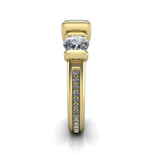 Fatima emerald three stone engagement ring in 14K Yellow Gold, side profile showing the pavé running down the band and the bar-set side stones in profile