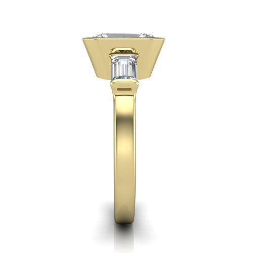 Amanda emerald three stone engagement ring in 14K Yellow Gold, side profile showing the tapered baguette side stone and the smooth tapered polished band