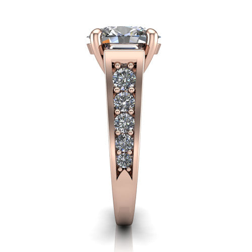 Estella oval three stone engagement ring in 18K Rose Gold, side profile showing the tapered baguette side stone and the round diamonds running down the shank