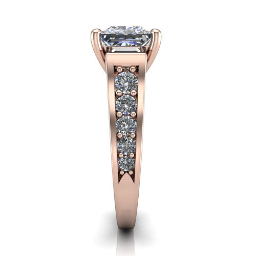 Estella princess three stone engagement ring in 18K Rose Gold, side profile showing the tapered baguette side stone and the round diamonds running down the shank