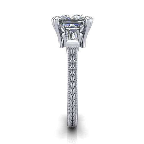 Camille princess three stone engagement ring in 18K White Gold, side profile showing the tapered baguette side stone and the hand-engraved wheat pattern down the band