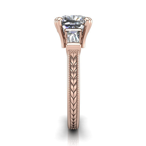 Camille cushion three stone engagement ring in 14K Rose Gold, side profile showing the tapered baguette side stone and the hand-engraved wheat pattern down the band