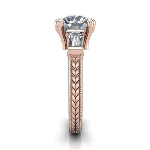 Camille round three stone engagement ring in 18K Rose Gold, side profile showing the tapered baguette side stone and the hand-engraved wheat pattern down the band