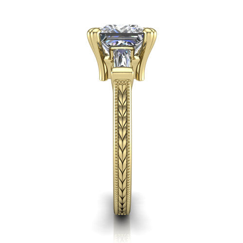 Camille princess three stone engagement ring in 14K Yellow Gold, side profile showing the tapered baguette side stone and the hand-engraved wheat pattern down the band