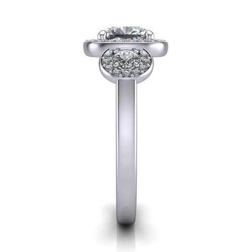 Wrenley cushion three stone engagement ring in Platinum, side profile showing a haloed round side stone and the smooth polished band