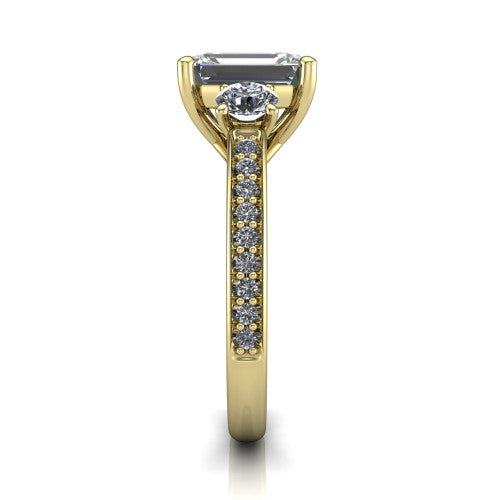 London emerald classic engagement ring in 18K Yellow Gold, side profile showing the round side stone and the pavé diamonds running down the shank