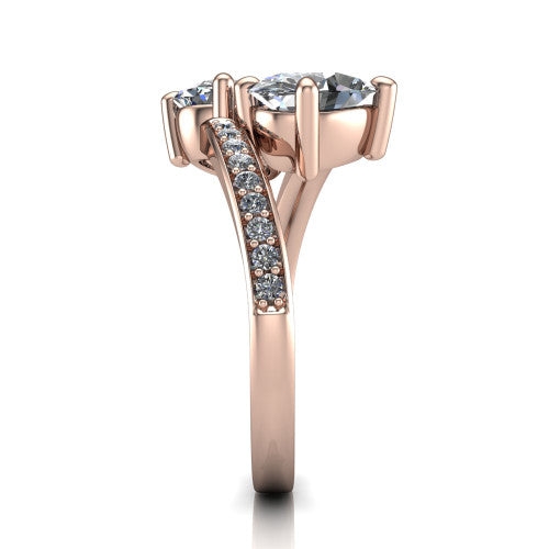 Payton oval three stone engagement ring in 18K Rose Gold, side profile showing the pavé split shank crossing in a bypass beneath the two-stone head