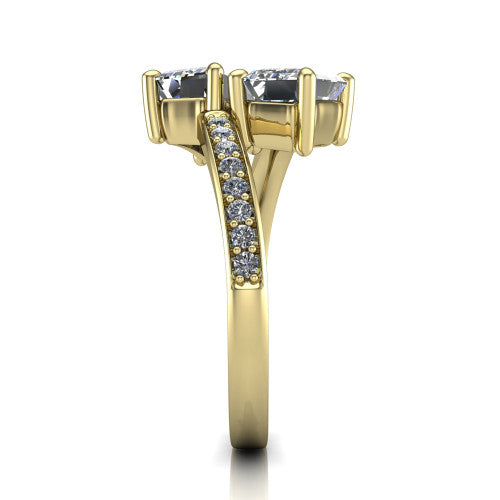 Payton emerald three stone engagement ring in 14K Yellow Gold, side profile showing the pavé split shank crossing in a bypass beneath the two-stone head