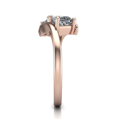 Alayna princess three stone engagement ring in 18K Rose Gold, side profile showing the bypass swirl shoulders crossing beneath the two-stone head
