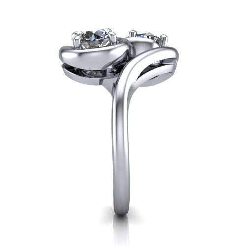 Daniela round three stone engagement ring in Platinum, side profile showing the bypass shank sweeping up and crossing behind the two-stone head