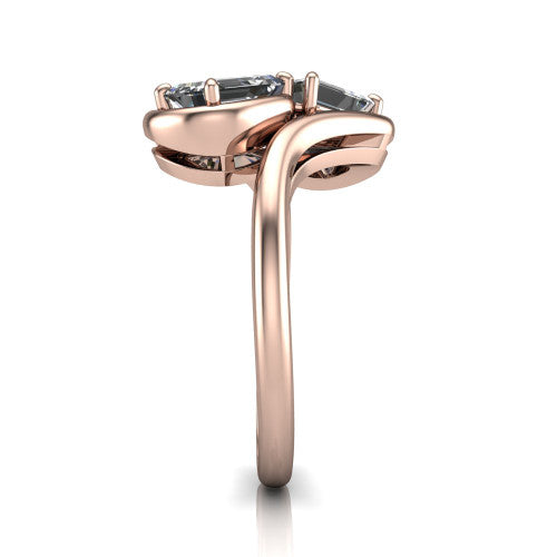 Daniela cushion three stone engagement ring in 18K Rose Gold, side profile showing the bypass shank sweeping up and crossing behind the two-stone head