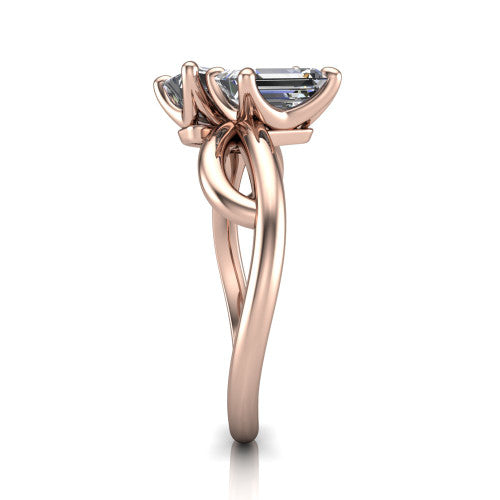 Mya emerald three stone engagement ring in 14K Rose Gold, side profile showing the band crossing beneath the head as a smooth polished infinity loop