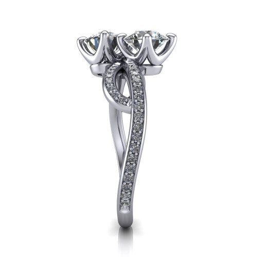 Angelina round three stone engagement ring in Platinum, side profile showing the band crossing beneath the head as a pave-covered infinity loop