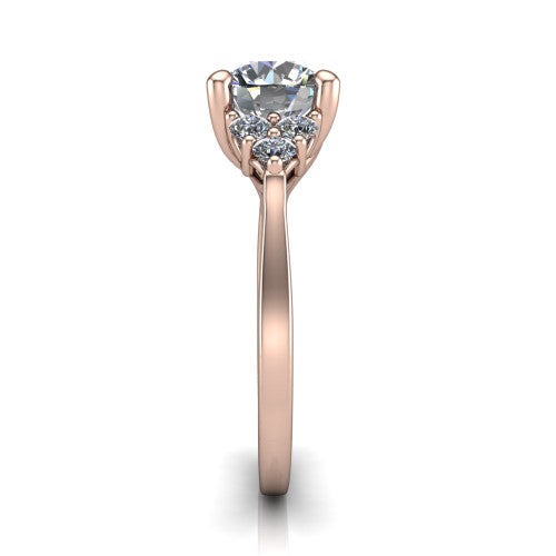 Raegan round three stone engagement ring in 14K Rose Gold, side profile showing the cluster head, tall basket, and slim polished band