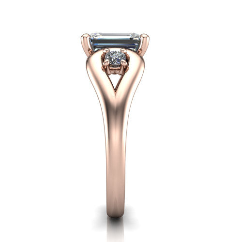 Imani emerald three stone engagement ring in 18K Rose Gold, side profile showing the bypass loop shoulders curving through the square side frames and slim polished band
