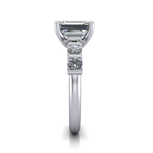 Liora emerald solitaire engagement ring in Platinum, side profile showing the side accents and polished band