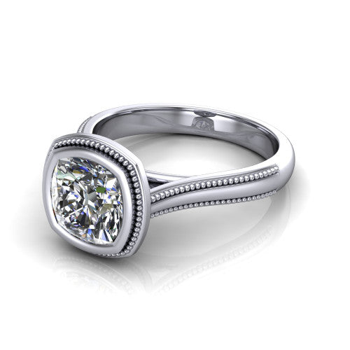 Adelina cushion solitaire engagement ring in Platinum, three-quarter perspective showing the brilliant cushion-cut center diamond, full bezel setting with milgrain detail, and tapered split-shoulder shank
