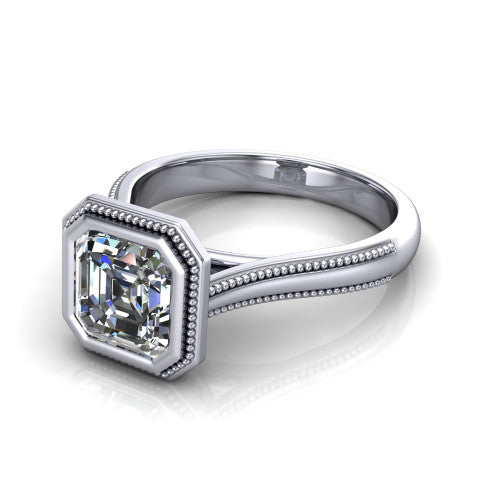 Adelina square emerald solitaire engagement ring in 18K White Gold, three-quarter perspective showing the step-cut square emerald center diamond, full bezel setting with milgrain detail, and tapered split-shoulder shank
