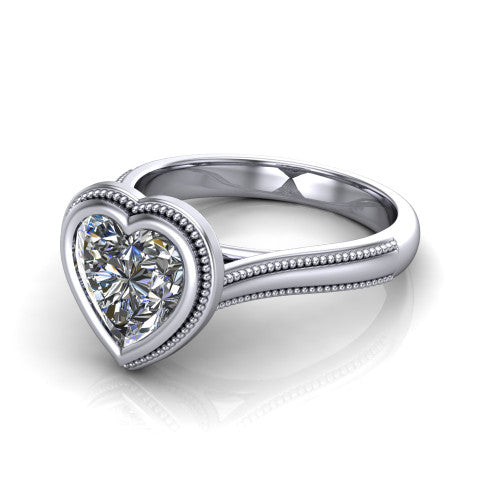 Adelina heart solitaire engagement ring in 14K White Gold, three-quarter perspective showing the brilliant heart-cut center diamond, full bezel setting with milgrain detail, and tapered split-shoulder shank