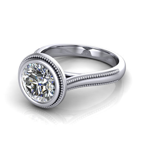 Adelina round solitaire engagement ring in Platinum, three-quarter perspective showing the brilliant round center diamond, full bezel setting with milgrain detail, and tapered split-shoulder shank