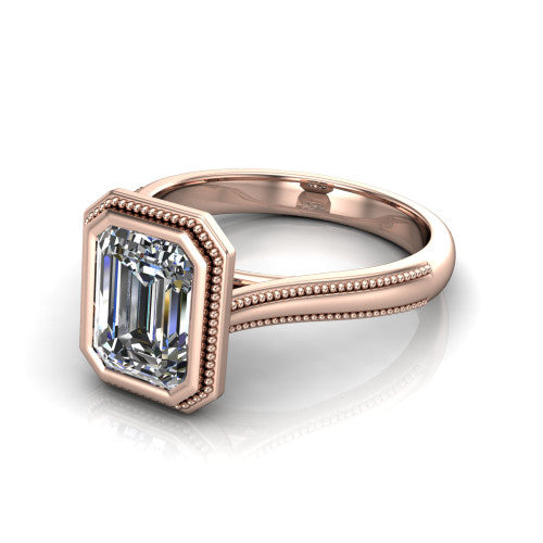 Adelina emerald solitaire engagement ring in 18K Rose Gold, three-quarter perspective showing the step-cut emerald center diamond, full bezel setting with milgrain detail, and tapered split-shoulder shank