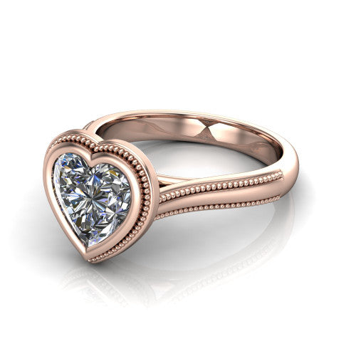 Adelina heart solitaire engagement ring in 18K Rose Gold, three-quarter perspective showing the brilliant heart-cut center diamond, full bezel setting with milgrain detail, and tapered split-shoulder shank