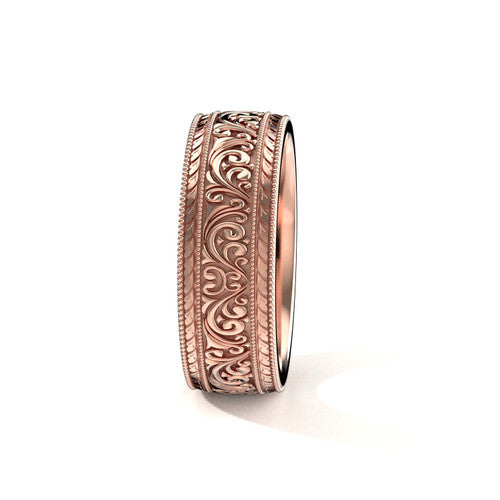 Handcrafted men's rose gold wedding band featuring detailed scrollwork and engraved accents