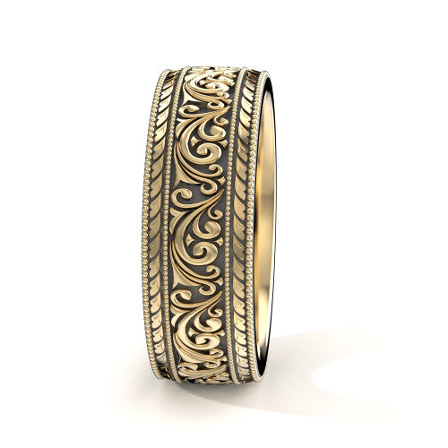 Close-up of engraved scrollwork on men's 14K yellow gold wedding ban
