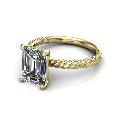 Claire emerald classic solitaire engagement ring in 18K Yellow Gold — three-quarter perspective showing the emerald-cut center diamond, 4-prong setting, and twisted rope shank