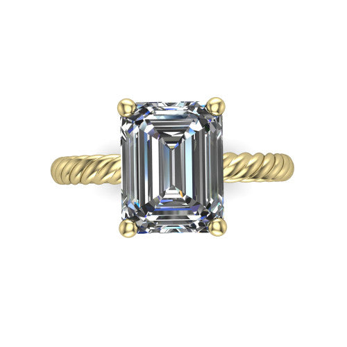 Claire emerald classic solitaire engagement ring in 18K Yellow Gold — top-down view showing the emerald-cut center stone and four prongs