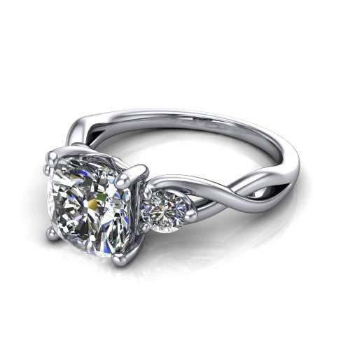 Lydia cushion three stone engagement ring in 18K White Gold, three-quarter perspective showing the brilliant cushion-cut center diamond flanked by two round side diamonds on a woven infinity shank