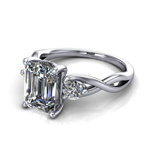 Lydia emerald three stone engagement ring in 18K White Gold, three-quarter perspective showing the step-cut emerald center diamond flanked by two round side diamonds on a woven infinity shank
