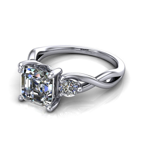 Lydia square emerald three stone engagement ring in Platinum, three-quarter perspective showing the step-cut square emerald center diamond flanked by two round side diamonds on a woven infinity shank