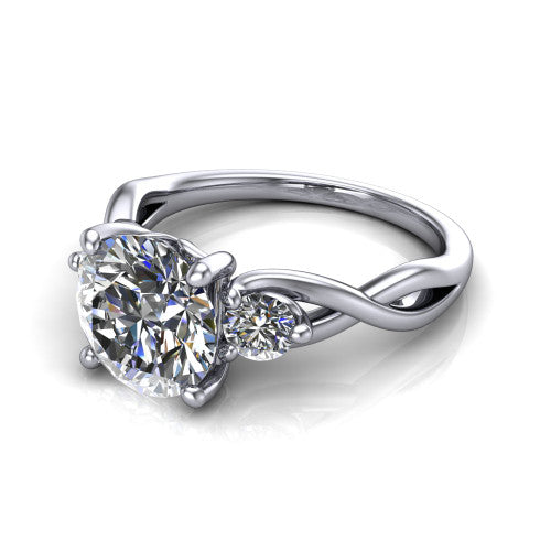 Lydia round three stone engagement ring in 18K White Gold, three-quarter perspective showing the brilliant round center diamond flanked by two round side diamonds on a woven infinity shank