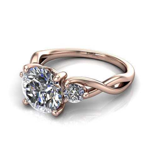 Lydia round three stone engagement ring in 14K Rose Gold, three-quarter perspective showing the brilliant round center diamond flanked by two round side diamonds on a woven infinity shank