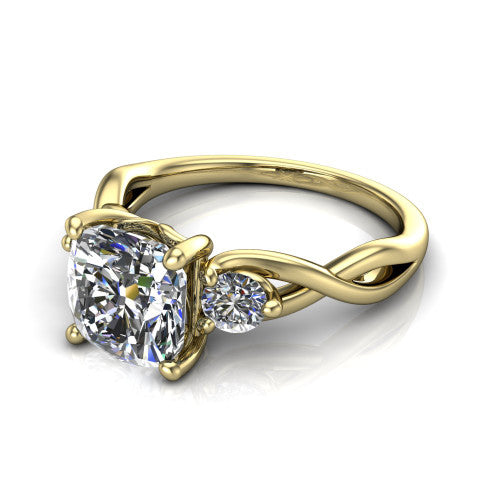 Lydia cushion three stone engagement ring in 14K Yellow Gold, three-quarter perspective showing the brilliant cushion-cut center diamond flanked by two round side diamonds on a woven infinity shank
